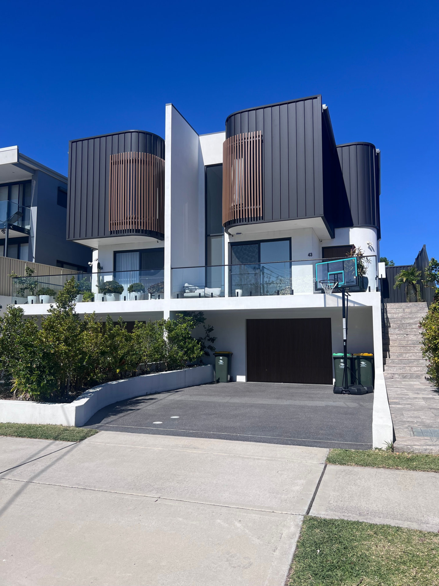 Modern multi-storey townhouse facade with blue sky